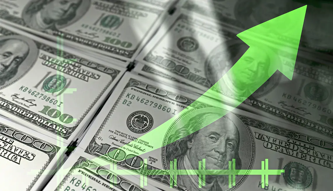 a stack of money with a green arrow pointing up